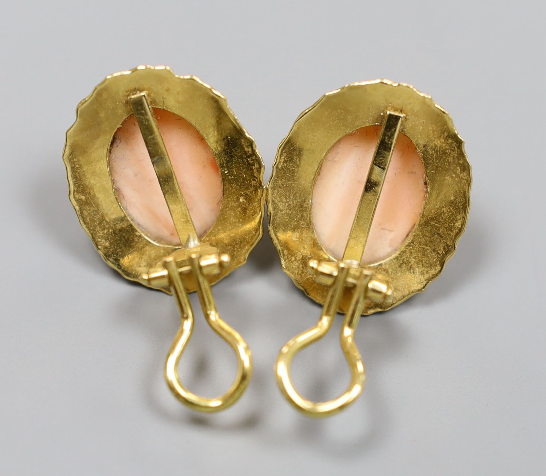 A pair of modern 750 and fluted coral bead set ear clips, 23mm, gross 10.7 grams.